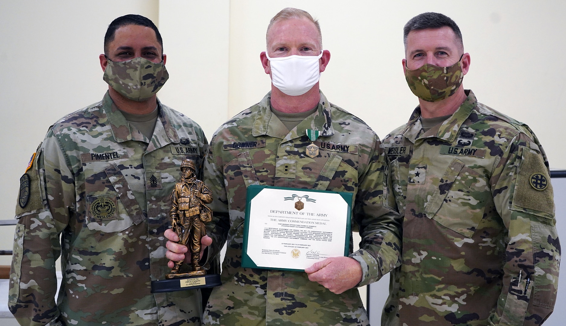 Chief Warrant Officer 2 Thomas Downer (center) receives and Army Commendation Medal from Brig. Gen. Kevin F. Meisler (right), commanding general of  the 4th Sustainment Command (Expeditionary), and 1st Sgt. Jorge Pimentel (left), 4th ESC Headquarter Company First Sergeant.