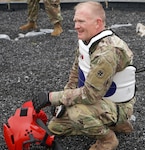Chief Warrant Officer 2 Thomas Downer takes a breather before competing in the final round of the pugile stick fight on day three of the competition at Joint Base San Antonio-Camp Bullis Feb. 25.