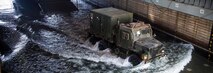 GULF OF ADEN - A U.S. Marine Medium Tactical Vehicle Replacement 7-ton truck with Combat Logistics Battalion 13, 13th Marine Expeditionary Unit (MEU), drives onto the well deck from Landing Craft Utility 1680 aboard the Whidbey Island-class dock landing ship USS Rushmore (LSD 47), Sept. 20, 2018. The Essex Amphibious Ready Group and 13th MEU are deployed to the U.S. 5th Fleet area of operations in support of naval operations to ensure maritime stability and security in the Central Region, connecting the Mediterranean and the Pacific through the western Indian Ocean and three strategic choke points. (U.S. Marine Corps photo by Cpl. Danny Gonzalez/Released)