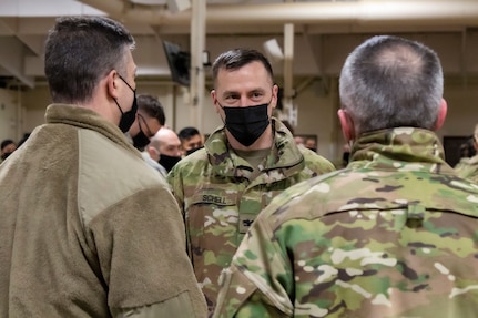 Col. Matthew Schell, commander of the 297th Regional Support Group, speaks with Maj. Gen. Torrence Saxe, adjutant general of the Alaska National Guard, and Chief Master Sgt. Winfield Hinkley, the senior enlisted leader for the Alaska National Guard, after the 297th RSG returned to Alaska from their nine-month long deployment in Poland, March 4, 2021, where they supported Operation Atlantic Resolve. Atlantic Resolve is a Department of Defense mission dedicated to demonstrating the continued commitment to peace, security and stability in Europe by the United States. (U.S. Army National Guard photo by Spc. Grace Nechanicky)