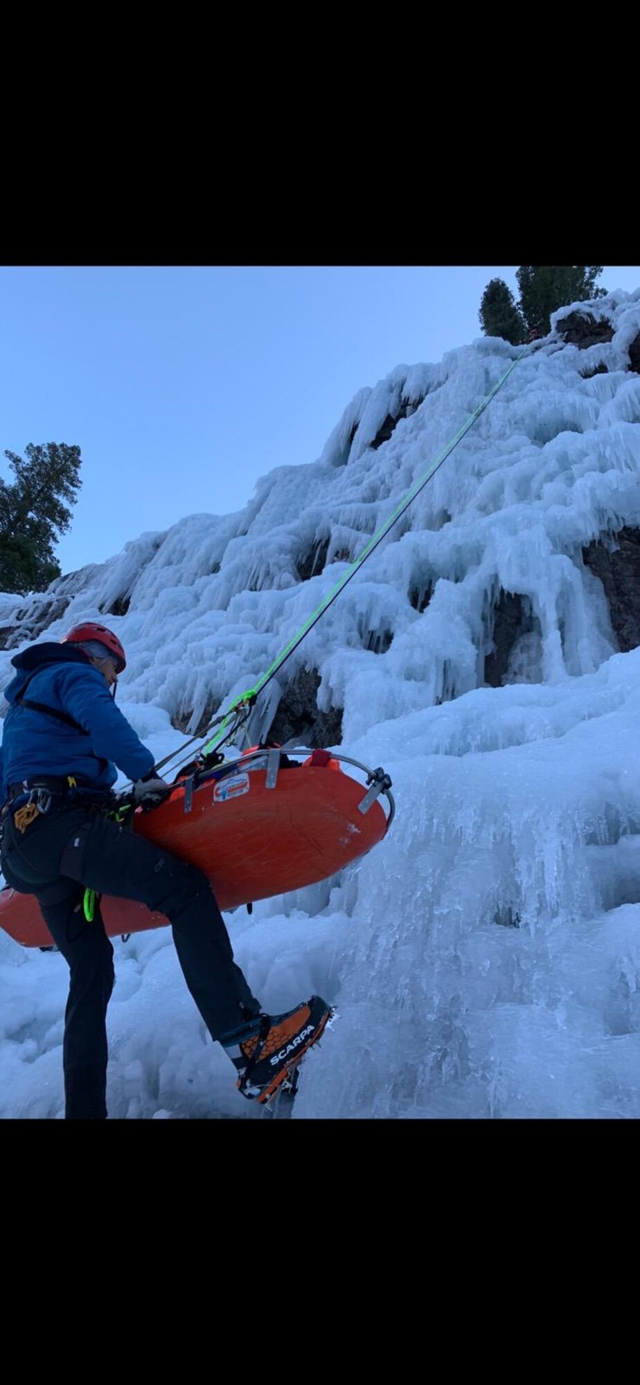 A civilian climber ascends an ice-wall with the rescue liter carrying an unidentified civilian climber. A Special Warfare Pararescue (PJ) eight-man team from Kirtland AFB, sprang into action to help rescue a civilian climber injured by falling rocks on January 7, 2021, in Ouray, CO.