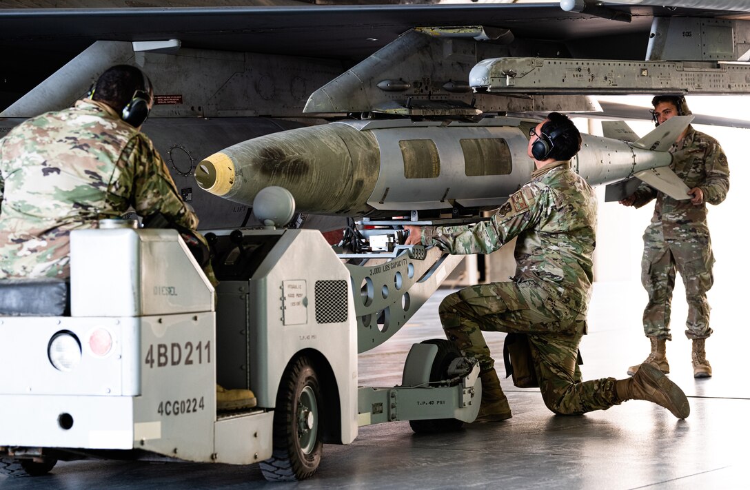 Weapons load crew members from the 77th Expeditionary Fighter Generation Squadron load munitions onto an F-16 Fighting Falcon during an integrated combat turn as part of anAgile Combat Employment capstone event March 2, 2021, at an airbase in the Kingdom of Saudi Arabia.