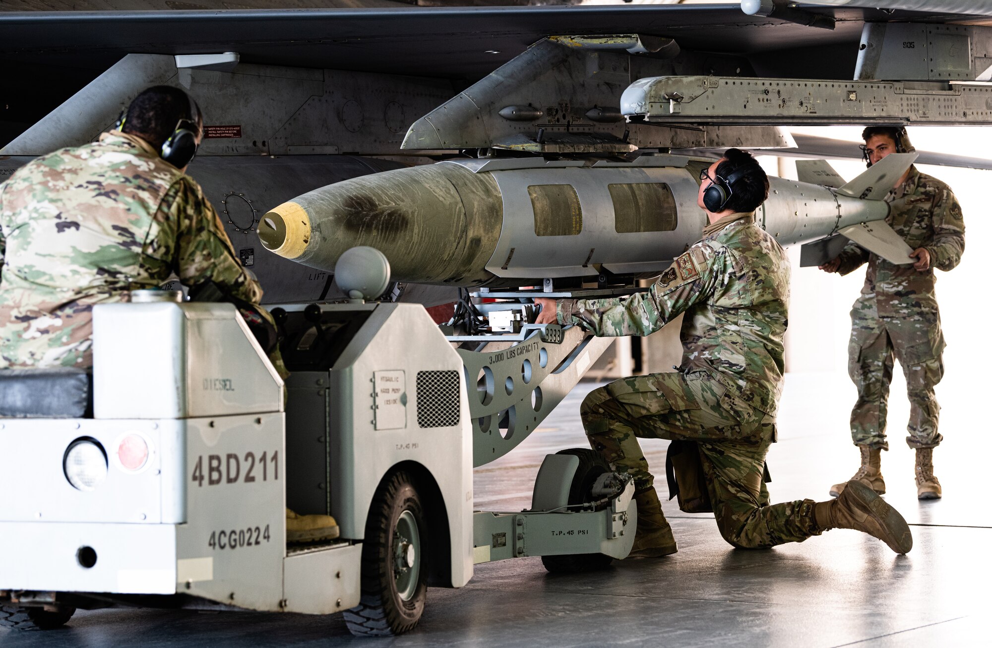 Weapons load crew members from the 77th Expeditionary Fighter Generation Squadron load munitions onto an F-16 Fighting Falcon during an integrated combat turn as part of anAgile Combat Employment capstone event March 2, 2021, at an airbase in the Kingdom of Saudi Arabia.