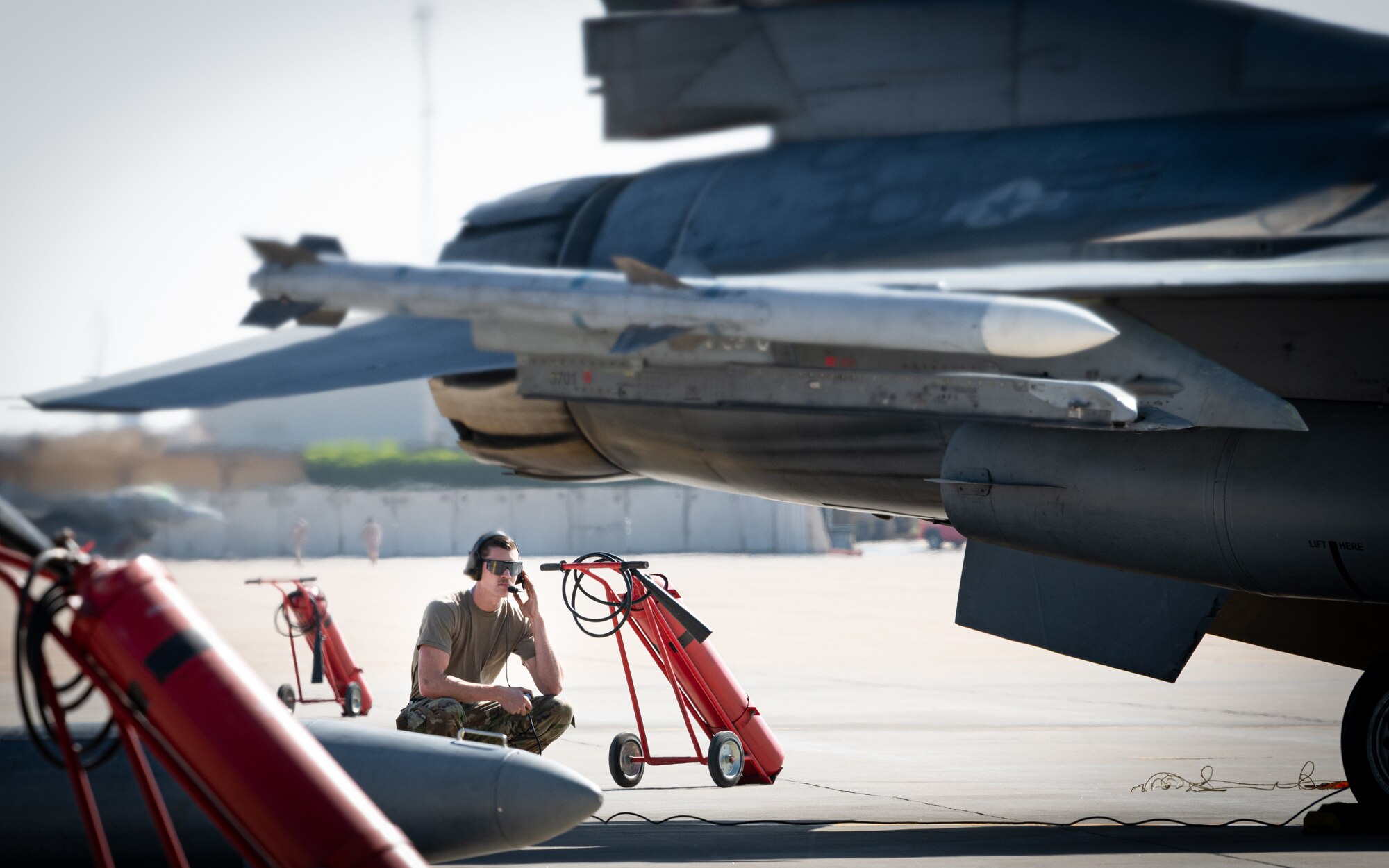 Senior Airman Lowe, 77th Expeditionary Fighter Generation Squadron crew chief, readies an F-16 Fighting Falcon for a mission during an Agile Combat Employment capstone event Feb. 27, 2021, at an airbase in the Kingdom of Saudi Arabia.