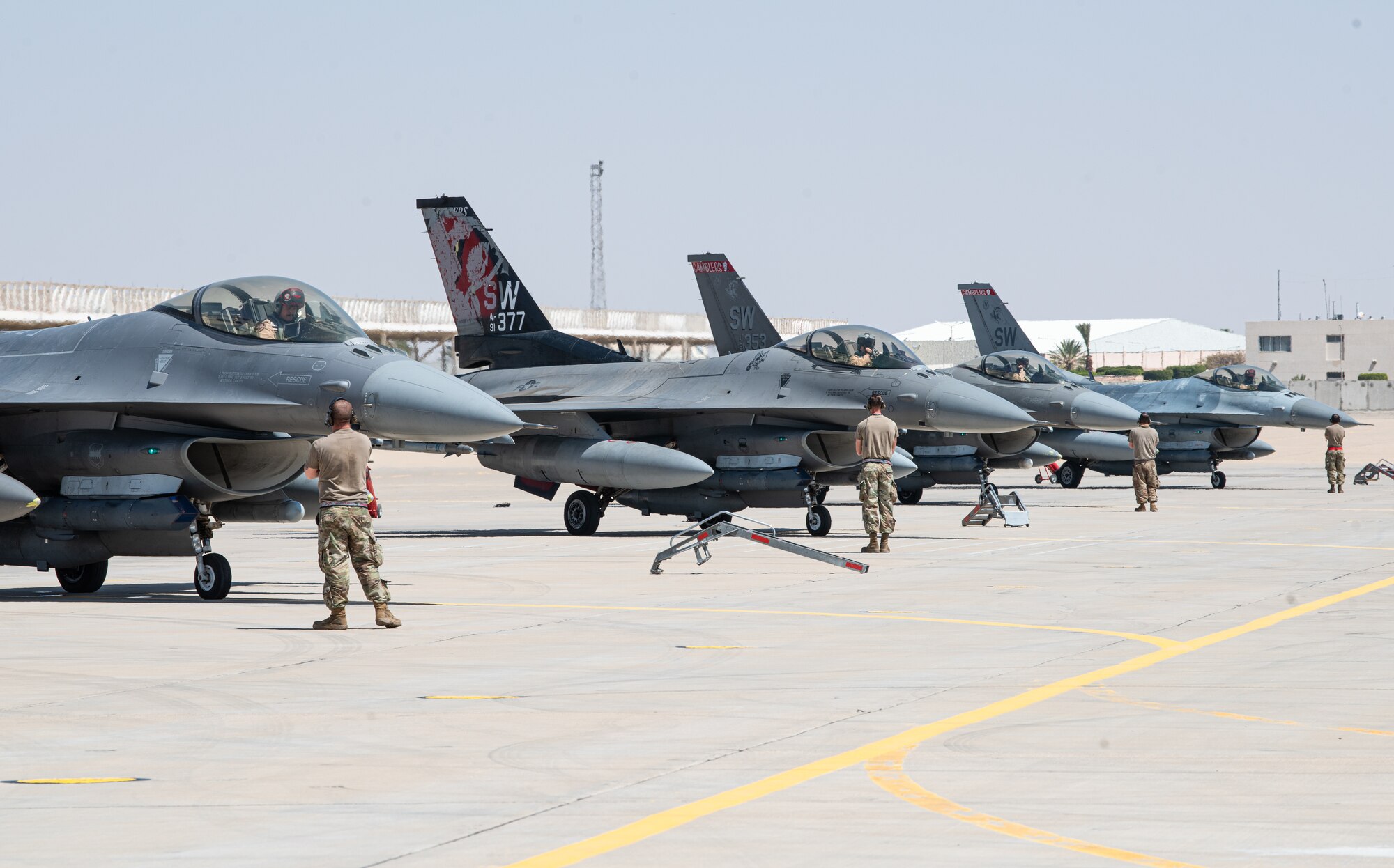 Crew chiefs from the 77th Fighter Generation Squadron and 77th Expeditionary Fighter Squadron pilots prepare for flight during an Agile Combat Employment capstone event March 5, 2021, at an airbase in the Kingdom of Saudi Arabia.