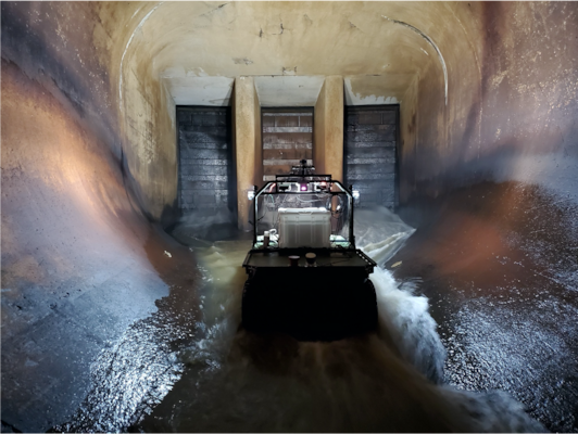 Principal Investigator Dr. Anton Netchaev stands near a robotic system known as the Dambot near the entrance of the outlet works at Blue Mountain Dam, Arkansas, in October 2020. Dambot takes the human element out of a dangerous but necessary U.S. Army Corps of Engineers (USACE) maintenance task. The cutting-edge technology has been successfully tested and stands poised to change the course of closure gate assessments, while also safeguarding USACE team members. (U.S. Army Corps of Engineers photo)