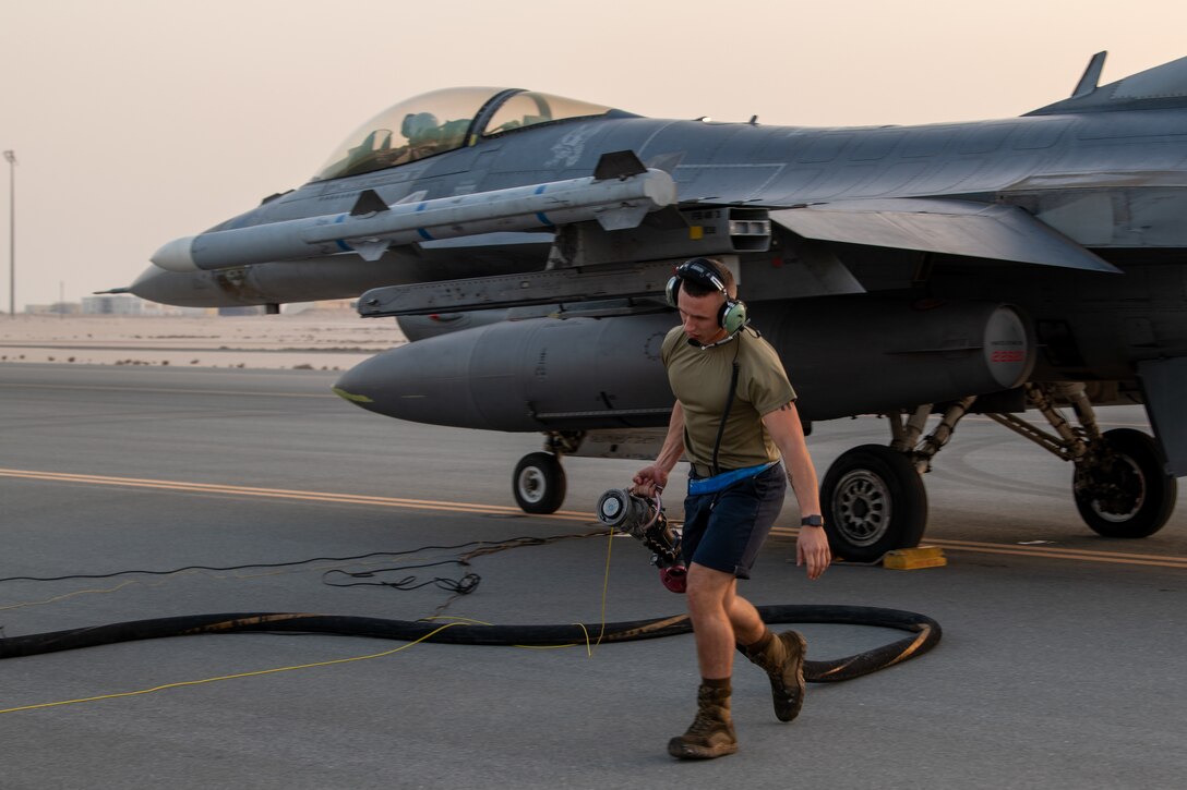 A U.S. Air Force F-16 Fighting Falcon aircraft assigned to the 77th Expeditionary Fighter Squadron at Prince Sultan Air Base, Kingdom of Saudi Arabia, undergoes a hot refueling operation performed by Airmen with the 379th Expeditionary Maintenance Group and 379th Expeditionary Logistics Readiness Squadron at Al Udeid Air Base, Qatar, Mar. 1, 2021. F-16s received fuel with their engines still running in order to rapidly redeploy back into U.S. Central Command’s area of responsibility during an Air Forces Central Agile Combat Employment capstone event.