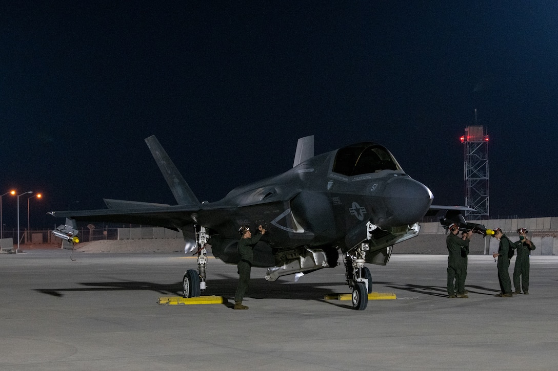 A U.S. Marines prepare to launch an F-35B Lightning II aircraft, assigned to the Marine Medium Tiltrotor Squadron 164 (Reinforced), 15th Marine Expeditionary Unit, by conducting a foreign object debris clearance walk during an Air Forces Central Agile Combat Employment Capstone event at Al Udeid Air Base, Qatar, March 3, 2021. The F-35B Lightning II is the U.S. Marine Corps variant of the 5th generation fighter. The capstone event enhanced theater ACE competencies, validating operational capabilities and command and control while simultaneously strengthening joint and regional partnerships.