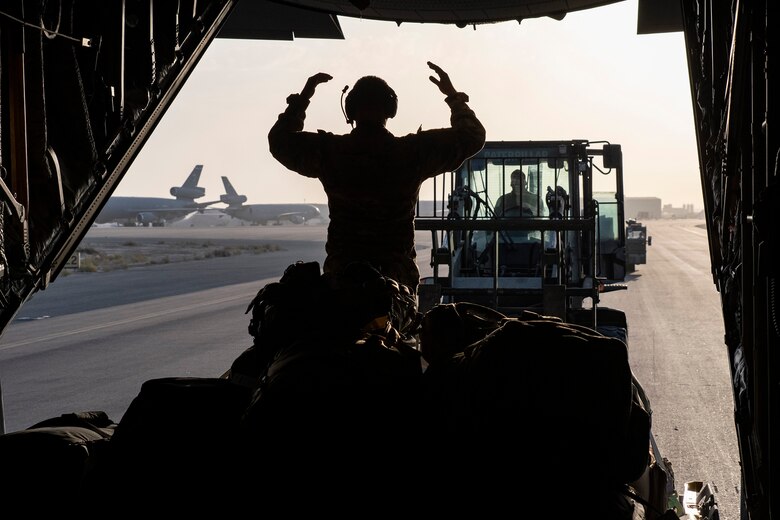 Airmen load a U.S. Air Force C-130 Hercules aircraft with cargo at Ali Al Salem Air Base, Kuwait, during an Air Forces Central Agile Combat Employment capstone mission March 3, 2021. The capstone event enhanced theater ACE competencies, validating operational capabilities and command and control while simultaneously strengthening joint and regional partnerships.