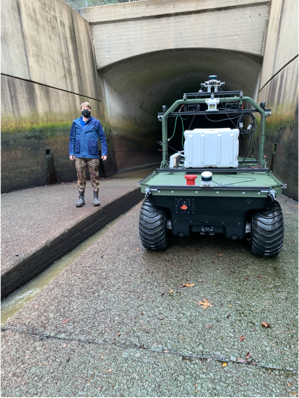 Principal Investigator Dr. Anton Netchaev stands near a robotic system known as the Dambot near the entrance of the outlet works at Blue Mountain Dam, Arkansas, in October 2020. Dambot takes the human element out of a dangerous but necessary U.S. Army Corps of Engineers (USACE) maintenance task. The cutting-edge technology has been successfully tested and stands poised to change the course of closure gate assessments, while also safeguarding USACE team members. (U.S. Army Corps of Engineers photo)