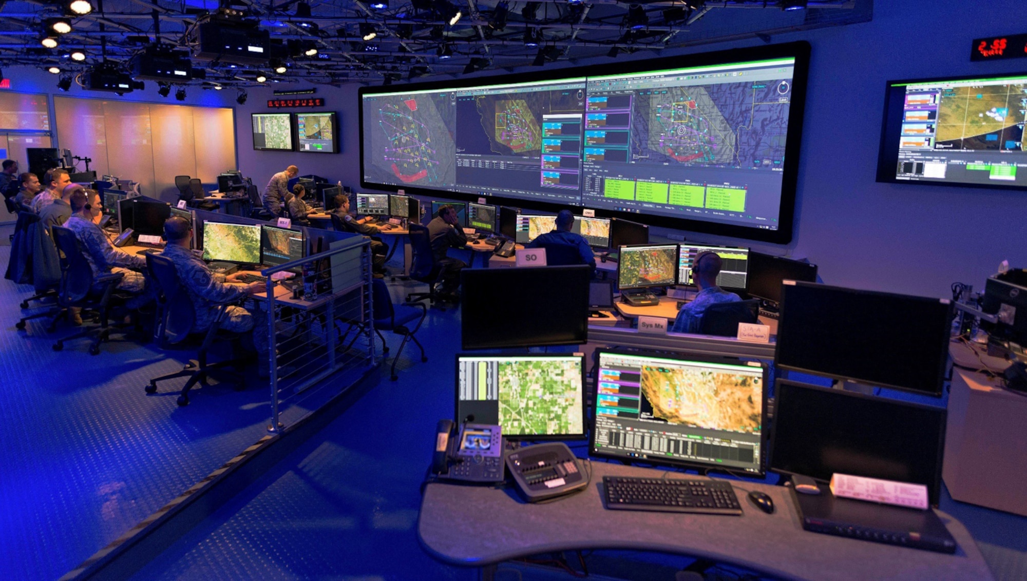 photo inside the Common Mission Control Center, Airmen working at computers