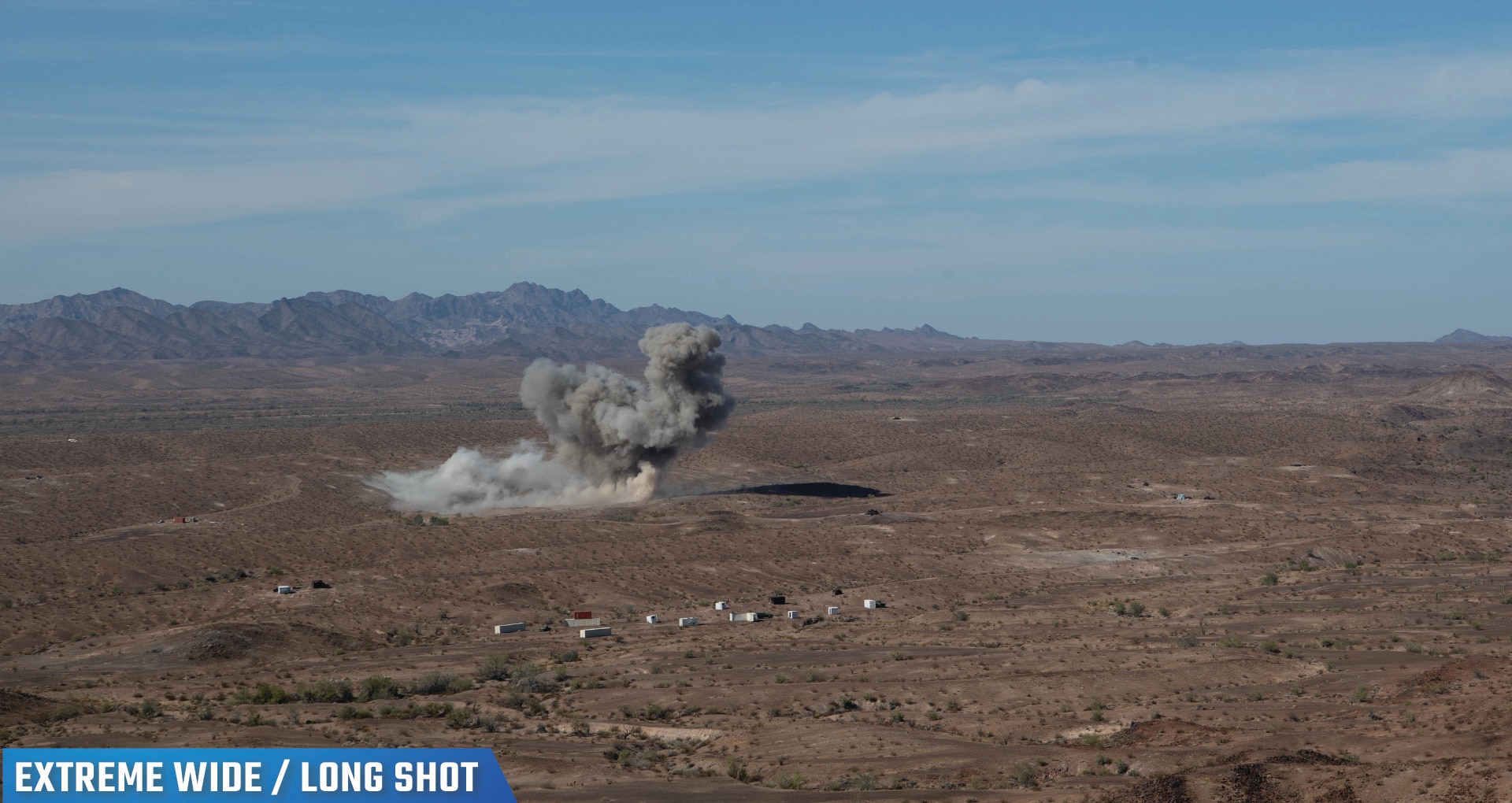 Photo of a desert-like landscape with smoke where a Bomb Squadron accurately struck a target during a Special Operations Terminal Attack Controller Course