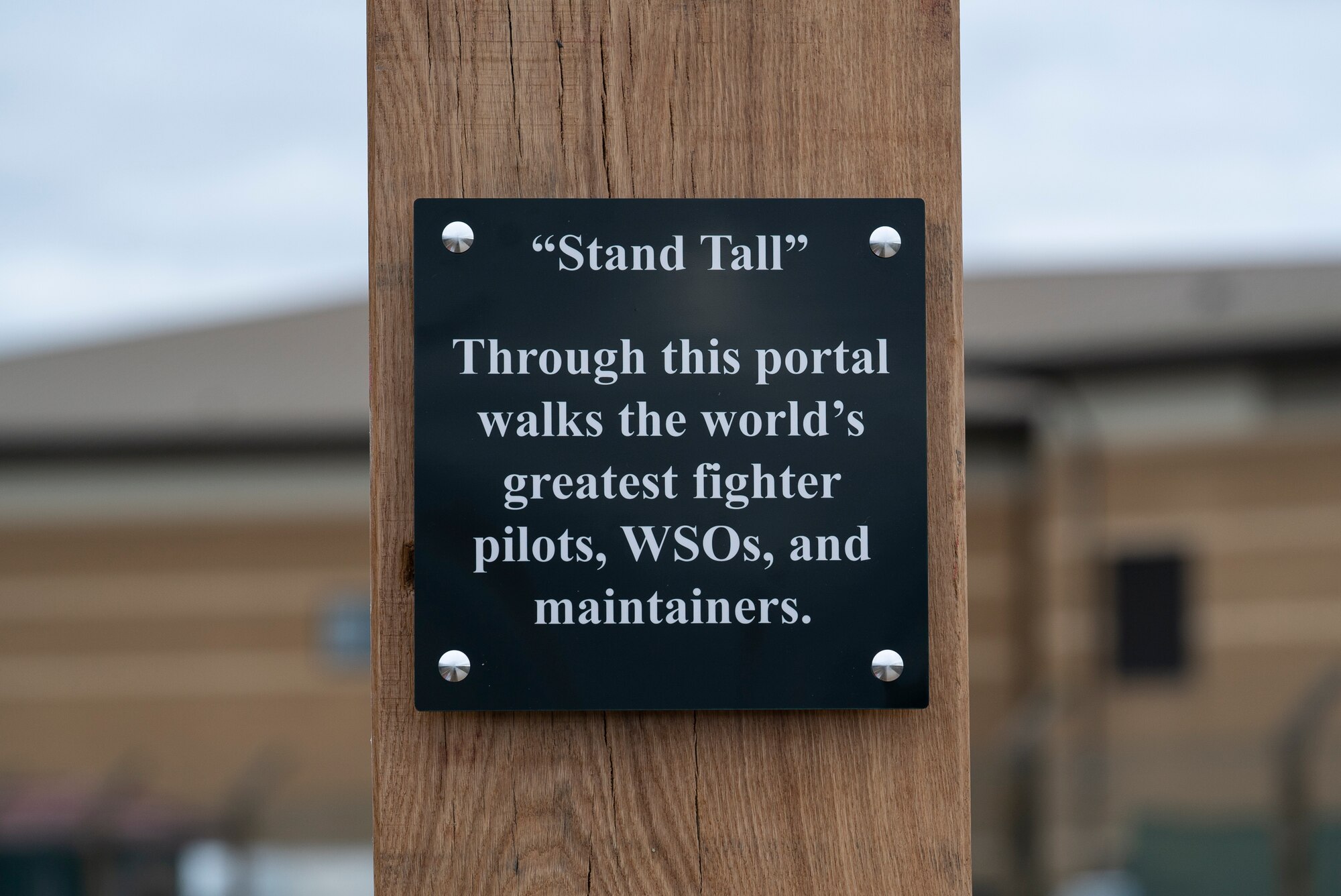 One of six plaques that adorns the new heritage arch at Royal Air Force Lakenheath, England, March 6, 2021. Eight museum panels adorn the support beams, containing inspirational words and showcasing stories of  48th Fighter Wing history and Air Force culture. (U.S. Air Force photo by Airman 1st Class Jessi Monte)
