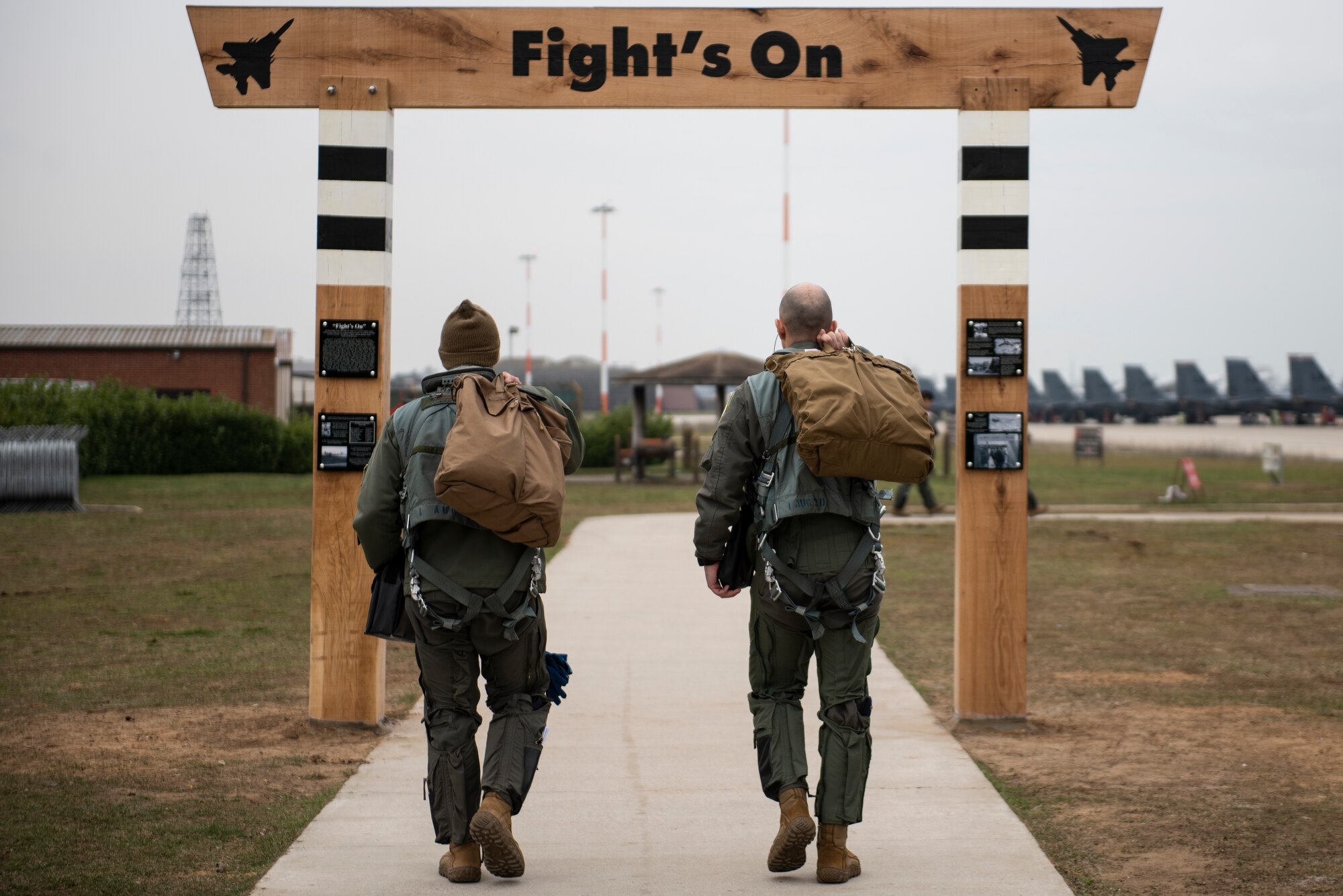 Aircrew assigned to the 494th Fighter Squadron step through the NEW heritage arch on their way to their aircraft at Royal Air Force Lakenheath, England, March 8, 2021. Liberty Wing aircrew and Airmen will walk under this arch on their way to carry out the 48th Fighter Wing mission for years to come. (U.S. Air Force photo by Airman 1st Class Jessi Monte)