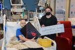 Taylor Roberts, a patient at Naval Medical Center Portsmouth’s (NMCP) Pediatric Oncology Department, receives a gaming gift from Operation Key West, March 4