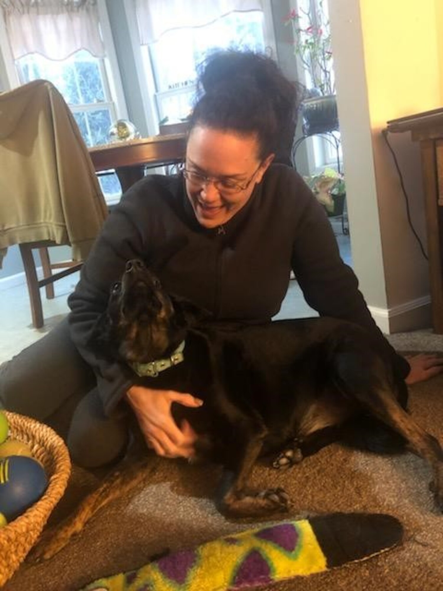 Air National Guardsman, Master Sgt. Jacquelyn Kennedy and her dog, Emma, show their affection for each other. Their bond began during a 2018 deployment. (U.S. Air Force courtesy photo)