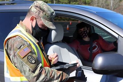 Fifty North Carolina National Guard Soldiers deployed to the PNC arena to support a drive-thru COVID-19 mass vaccination clinic in Raleigh, North Carolina, March 4, 2021. The Soldiers assigned to the NCNG’s 30th Armored Brigade Combat Team and 113th Sustainment Brigade directed vehicle traffic and provided logistical and administrative support for Wake County Emergency Management staff and volunteers.