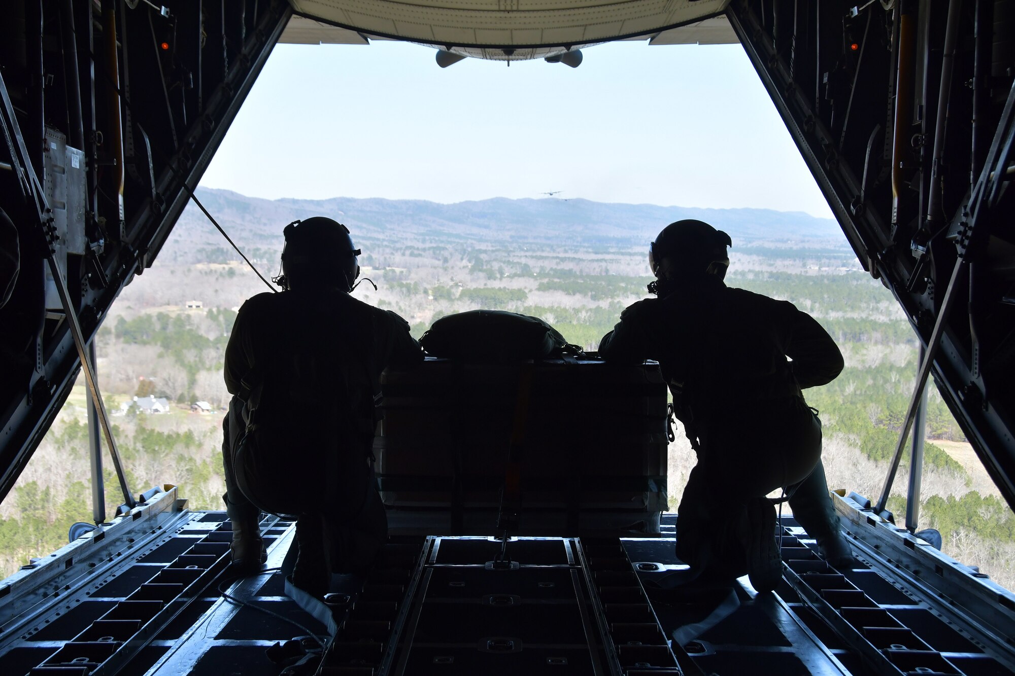 Master Sgts. Andrew S. Cline and Antwun T. Cotton, both 94th Operations Support Squadron loadmasters, prepare to drop a Low-Cost-Low-Altitude airdrop over Rome, Ga. March 4, 2021. Multiple C-130s flew together as part of Baltic Wolf 2021, a large formation exercise incorporating other units within the Air Force Reserve Command. (U.S. Air Force photo by Senior Airman Kendra A. Ransum)