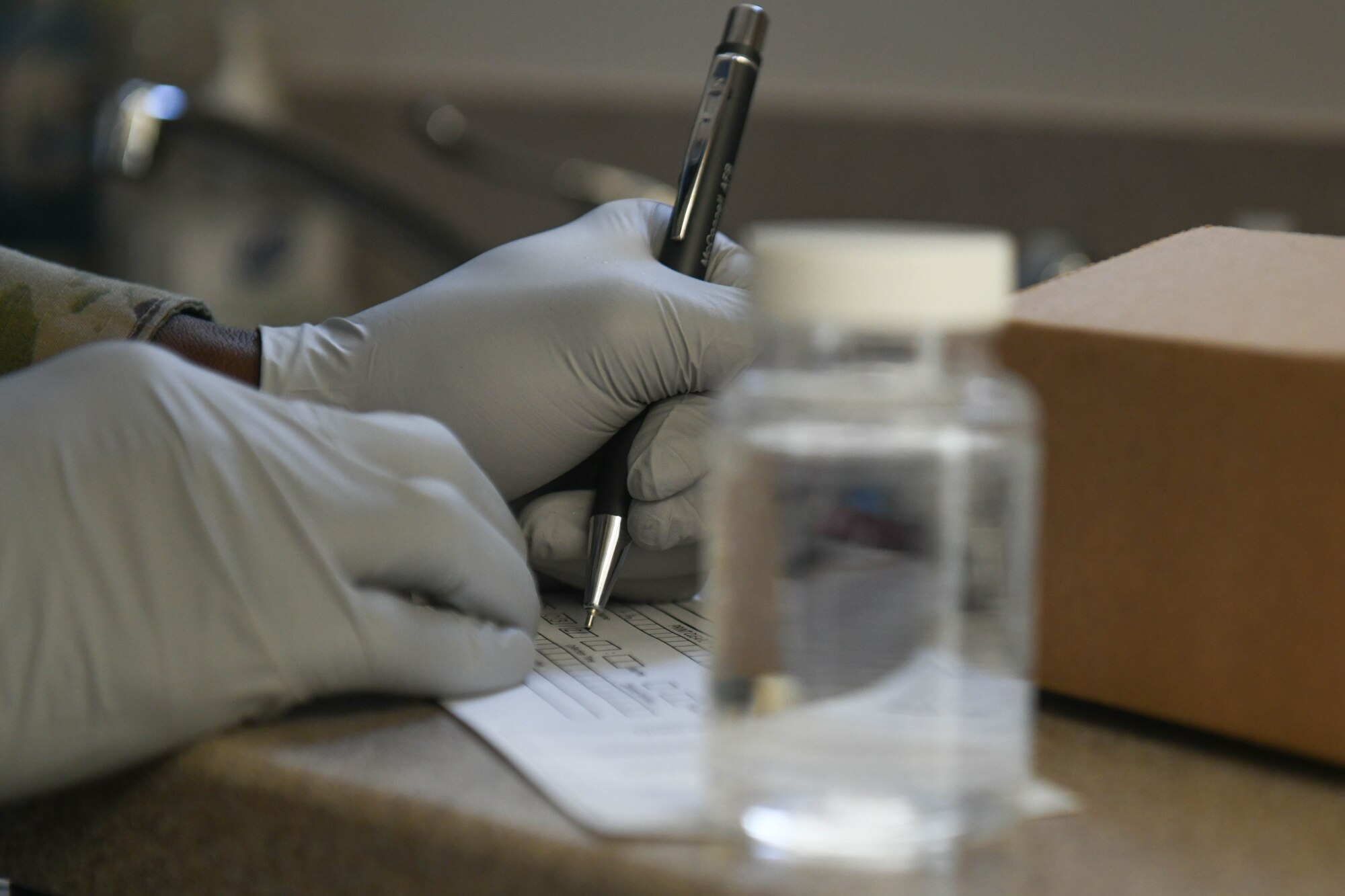 Airman 1st Class Ronald Smith, 22nd Operational Medical Readiness Squadron bioenvironmental engineering technician, fills out a chain of custody form Mar. 3, 2021, at McConnell Air Force Base, Kansas. This form allows for proper documentation of when, where and by whom the sample was taken. (U.S. Air Force photo by Senior Airman Nilsa Garcia)