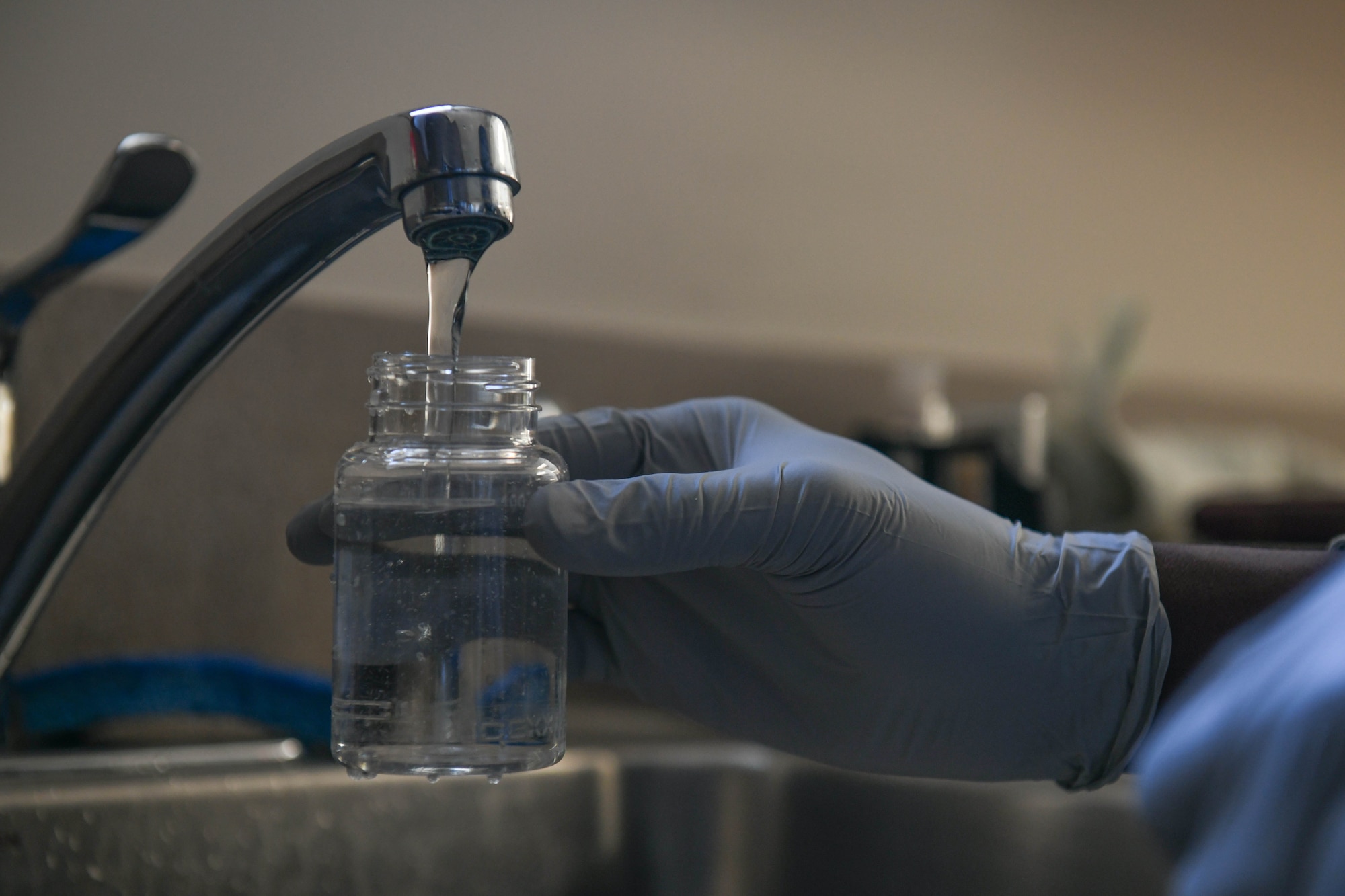 Airman 1st Class Ronald Smith, 22nd Operational Medical Readiness Squadron bioenvironmental engineering technician, collects a bacteria sample from water Mar. 3, 2021, at McConnell Air Force Base, Kansas. Water sampling for pH, chlorine and bacteria levels are performed weekly to ensure the quality and safety of the water being utilized and consumed by Airmen. (U.S. Air Force photo by Senior Airman Nilsa Garcia)