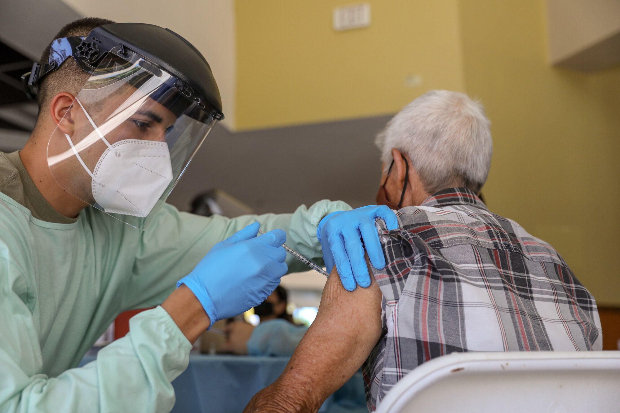 Sgt. Phillip Altuz of the Puerto Rico Army National Guard vaccinates a person at Aguadilla, Puerto Rico, March 4, 2021. The Puerto Rico National Guard assisted the Department of Health to vaccinate the elderly against COVID-19. (U.S. Army National Guard photo by Spc. Hassani Ribera)