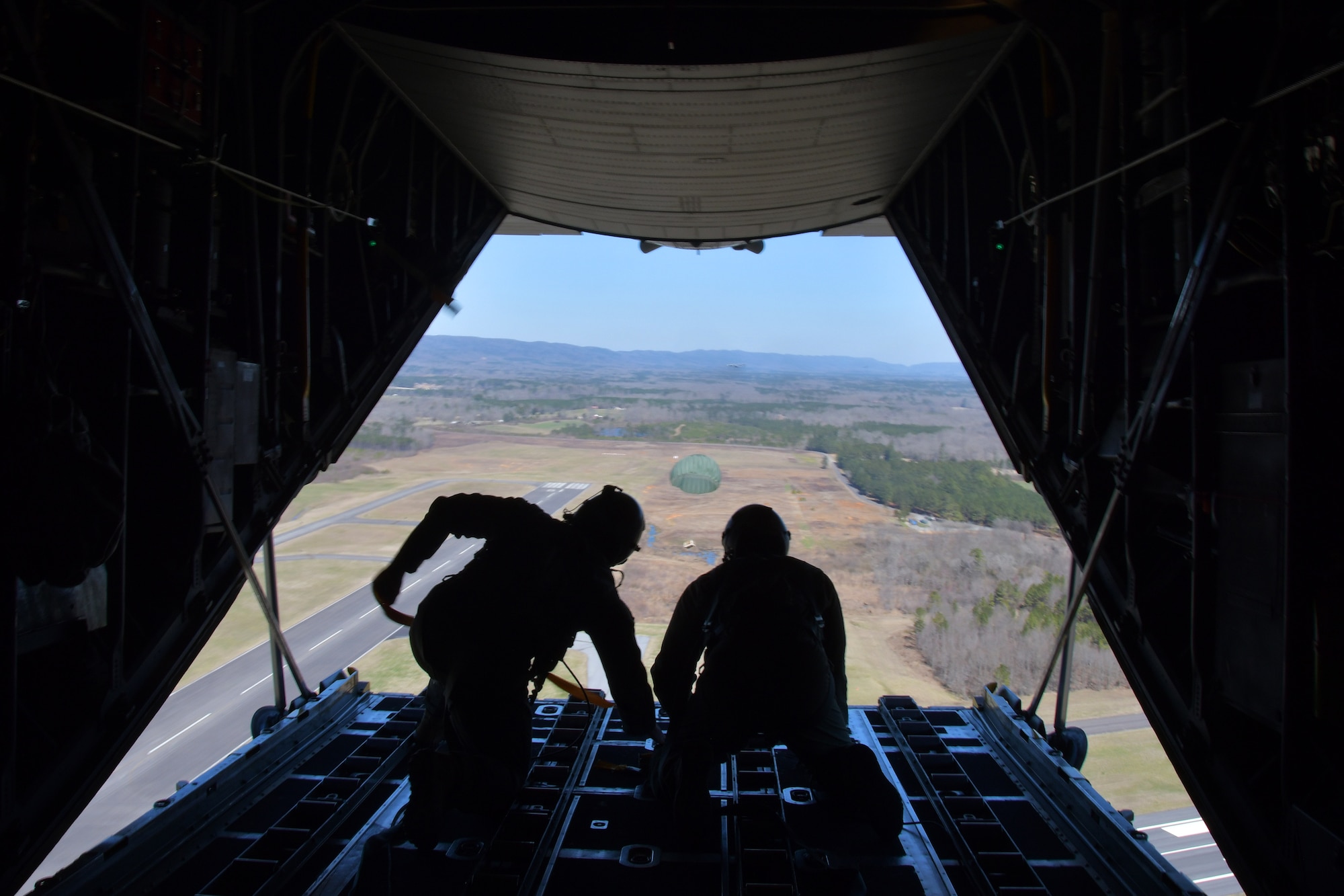 Master Sgts. Andrew S. Cline and Antwun T. Cotton, both 94th Operations Support Squadron loadmasters, release a Low-Cost-Low-Altitude airdrop over Rome, Ga. March 4, 2021. Multiple C-130s flew together as part of Baltic Wolf 2021, a large formation exercise incorporating other units within the Air Force Reserve Command. (U.S. Air Force photo by Senior Airman Kendra A. Ransum)