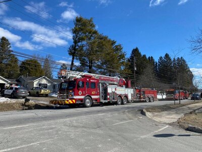 Photo of fire trucks outside home.