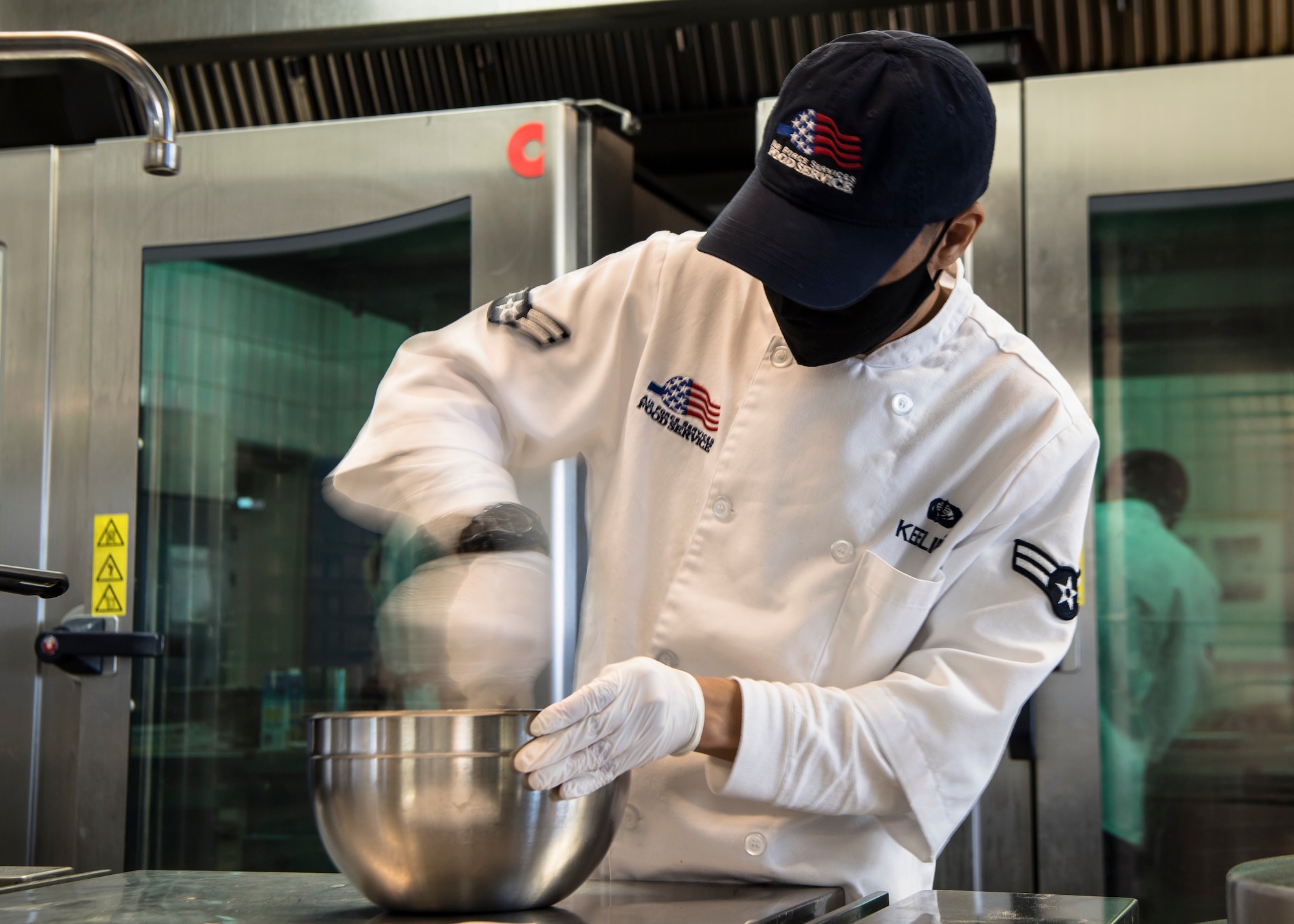 A man whisk food in a bowl.