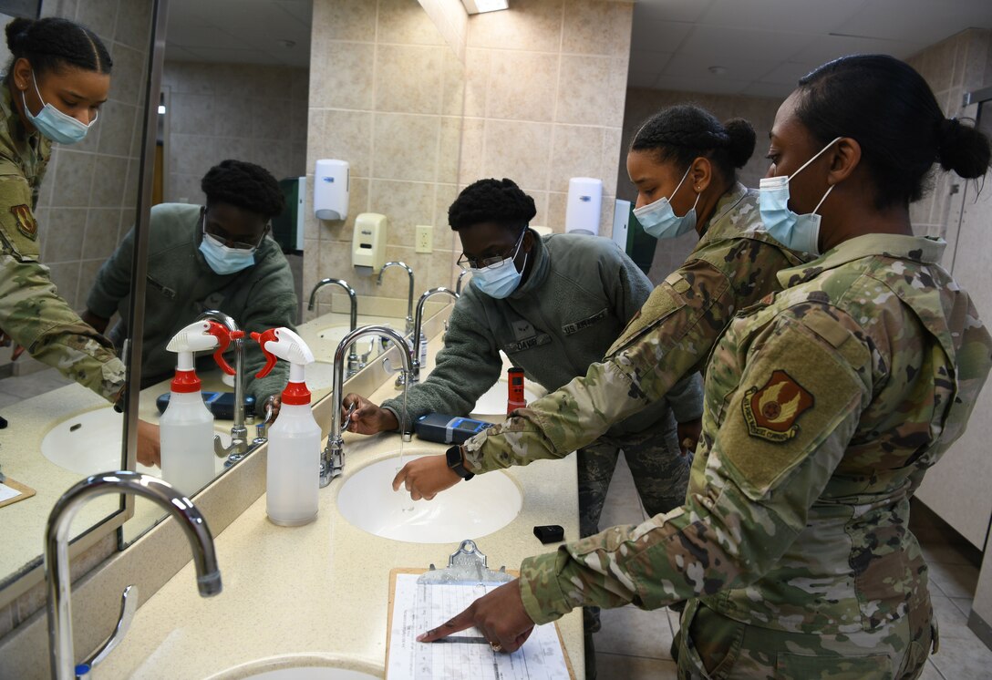 two women and man standing
