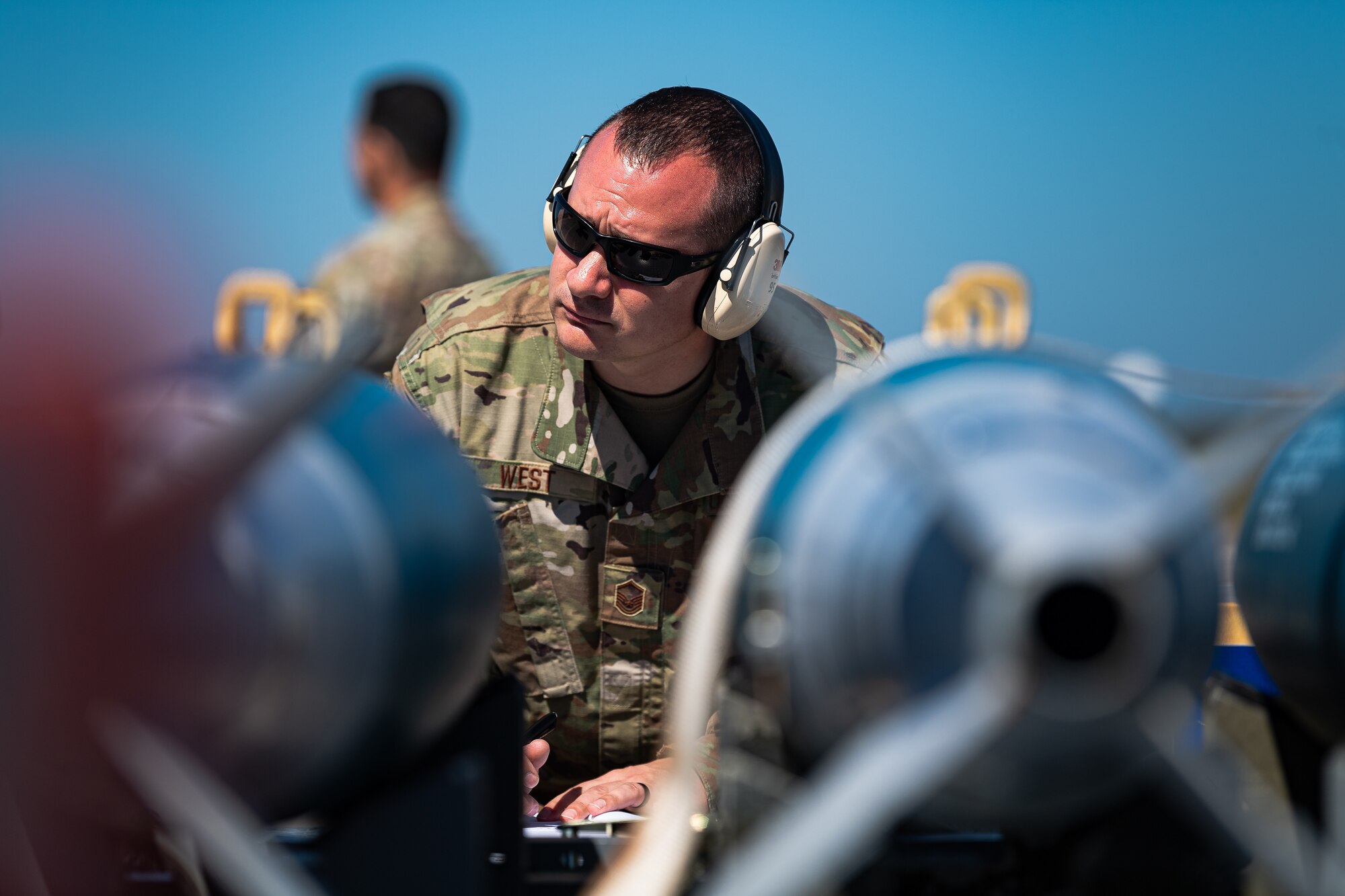 A photo of an Airman observing an integrated combat turn