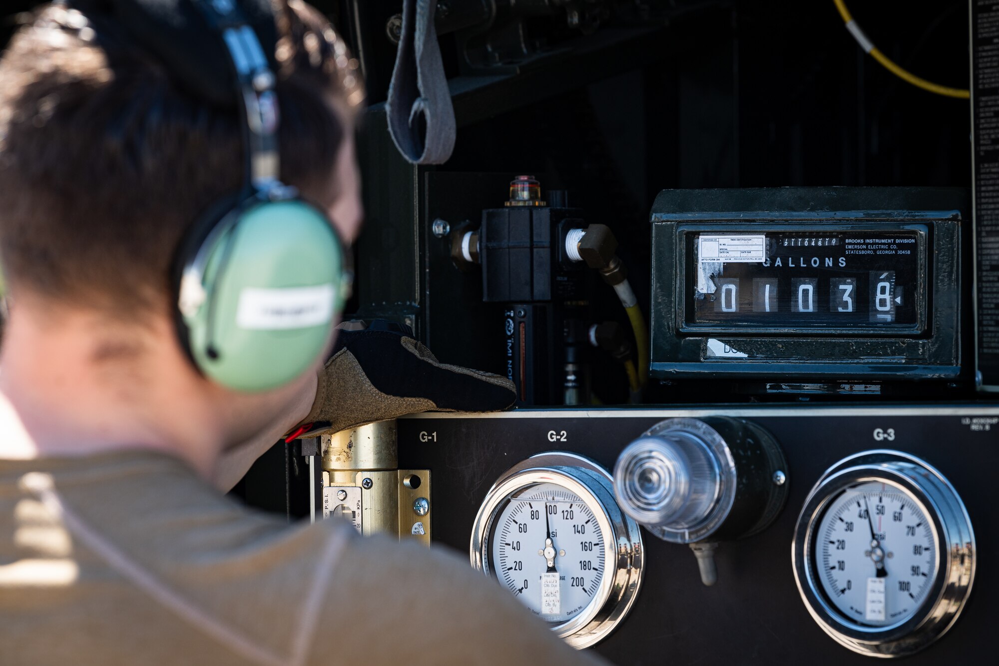 A photo of an Airman watching fuel gauges
