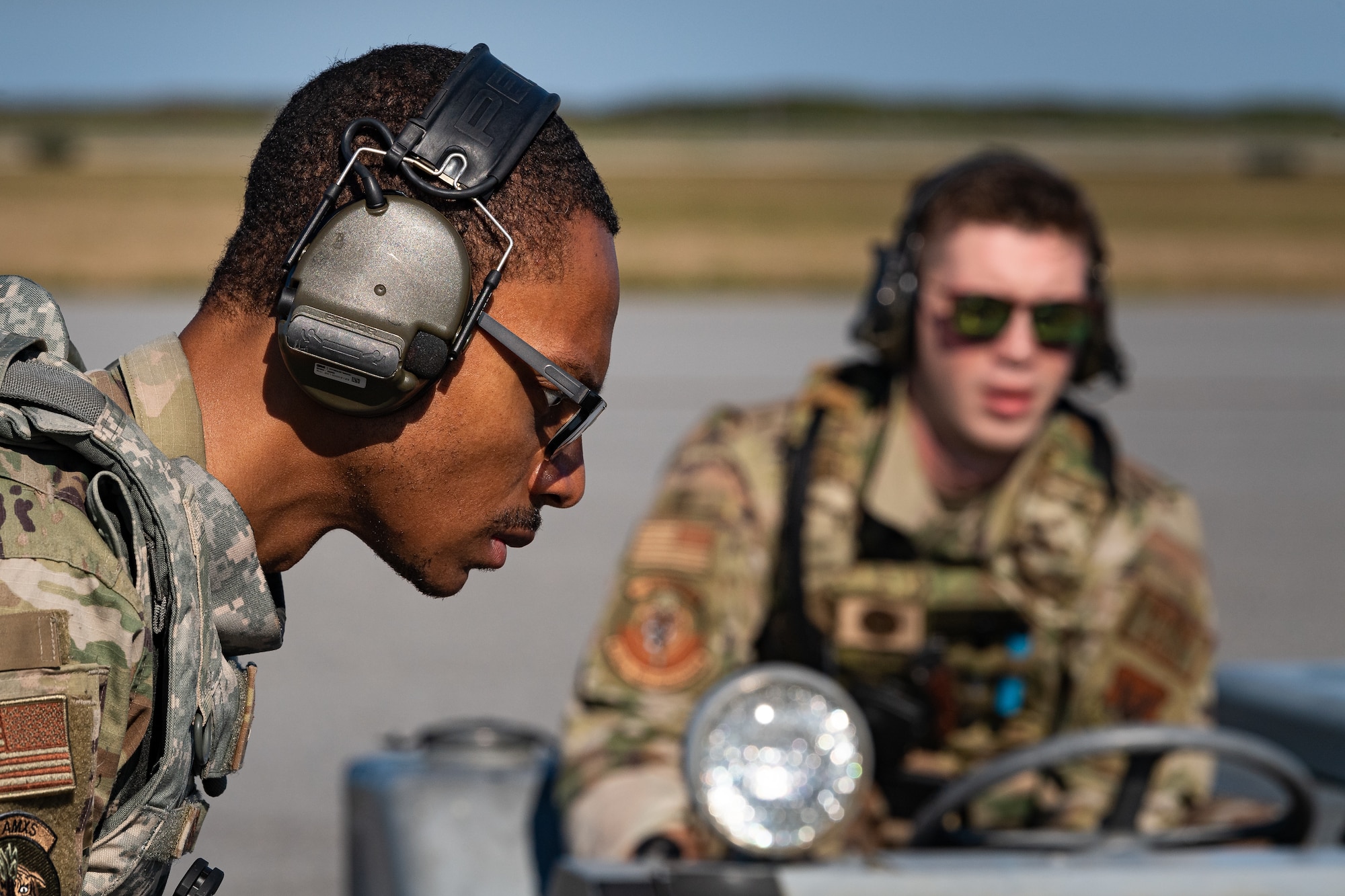 A photo of Airmen moving bombs on a weapons loader