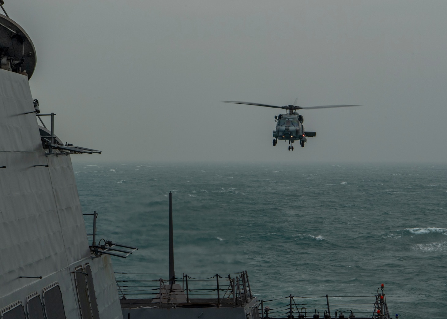 210310-N-SS350-1115 TAIWAN STRAIT (March 10, 2021) An MH-60R Sea Hawk, assigned to the “Magicians” of Helicopter Maritime Strike Squadron (HSM) 35, prepares to land on the flight deck of the Arleigh Burke-class guided-missile destroyer USS John Finn (DDG 113) March 10, 2021. John Finn, part of the Theodore Roosevelt Carrier Strike Group, is on a scheduled deployment to the U.S. 7th Fleet area of operations. As the U.S. Navy’s largest forward-deployed fleet, 7th Fleet routinely operates and interacts with 35 maritime nations while conducting missions to preserve and protect a free and open Indo-Pacific Region. (U.S. Navy photo by Mass Communication Specialist 3rd Class Jason Waite)