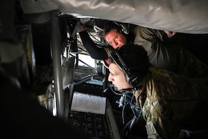 Senior Mast Sgt. Mark McGougan, 465th Air Refueling  Squadron boom operator, instructs Senior Airman Peter Whitfield, 46th ARS boom operator, during an aerial refueling event March 5, 2020, Tinker Air Force Base, Oklahoma. (U.S. Air Force photo by Senior Airman Mary Begy)
