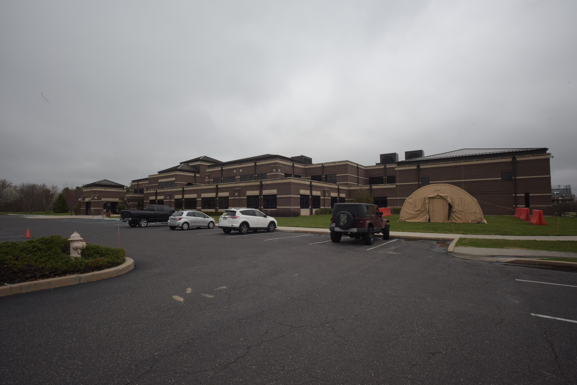 Members of the 87th Medical Group screen patients outside as a preventative measure to help reduce the spread of COVID-19 at Joint Base McGuire-Dix-Lakehurst, N.J., March 30, 2020. The process separates those with and without symptoms so they can test and evaluate patients effectively. If patients have symptoms they are directed to a station where medical personnel test them for COVID-19 while taking proper sanitary precautions.