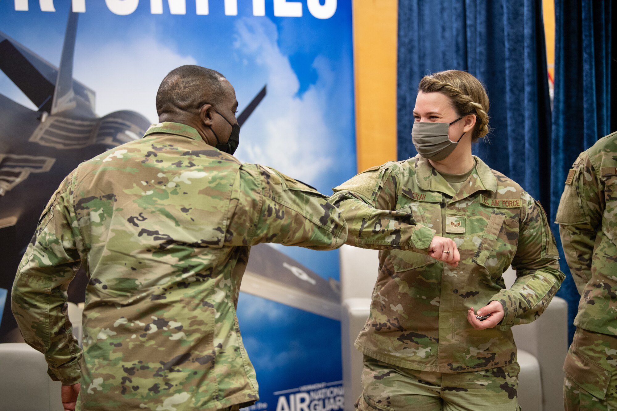U.S. Air Force Chief Master Sgt. Maurice L. Williams, command chief, Air National Guard (ANG), congratulates Senior Airman Lauren Cray, assigned to the 158th Medical Group.