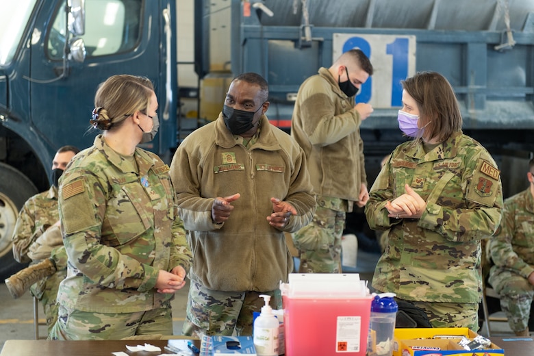 U.S. Air Force Chief Master Sgt. Maurice L. Williams, command chief, Air National Guard (ANG), speaks with Senior Airman Lauren Cray, left, and Staff Sgt. Sarah Basiliere, both assigned to the 158th Medical Group.