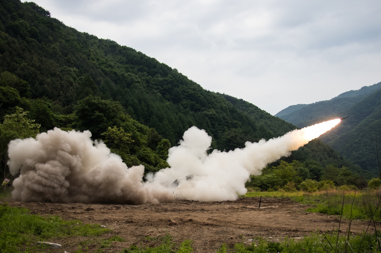 A rocket speeds away from a launch vehicle.