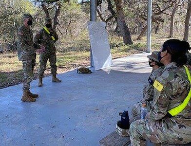 Pvt. Drew Smoker receives a command coin for excellence from U.S. Army Medical Center of Excellence Command Sgt. Maj. Clark Charpentier while assigned to the MEDCoE during Soldier in Transition Training, or SiTT, last month at Joint Base San Antonio-Fort Sam Houston.