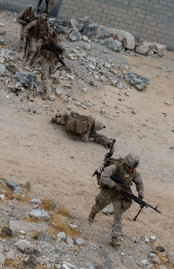 U.S. Marines with 3rd Battalion, 5th Marine Regiment, 1st Marine Division, cross a road during an urban assault training lane on Marine Corps Air-Ground Combat Center, Twentynine Palms, Calif., Jan. 21, 2021. The training is part of Integrated Training Exercise 2-21, a combined arms training exercise intended to produce combat ready forces capable of operating as an integrated Marine Air-Ground Task Force. (U.S. Marine Corps photo by Lance Cpl. Brian Bolin Jr.)