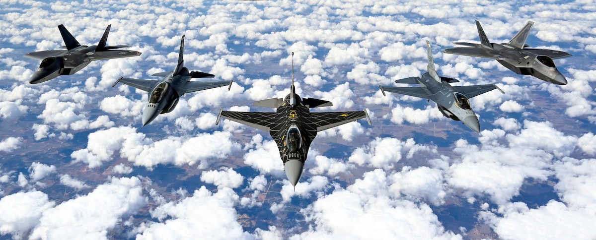 Pilots with the F-16 Viper and F-22 Raptor Demonstration Teams fly behind a KC-135 Stratotanker from the 465th Air Refueling Squadron assigned to Tinker Air Force Base, Oklahoma March 8, 2021. The F-16 team from Shaw Air Force Base, South Carolina, and the F-22 team from Joint Base Langley–Eustis, Virginia, are assigned to Air Combat Command and received fuel from the Okies during their flight back to their home stations after performing at an air show. (U.S. Air Force photo by Senior Airman Mary Begy)