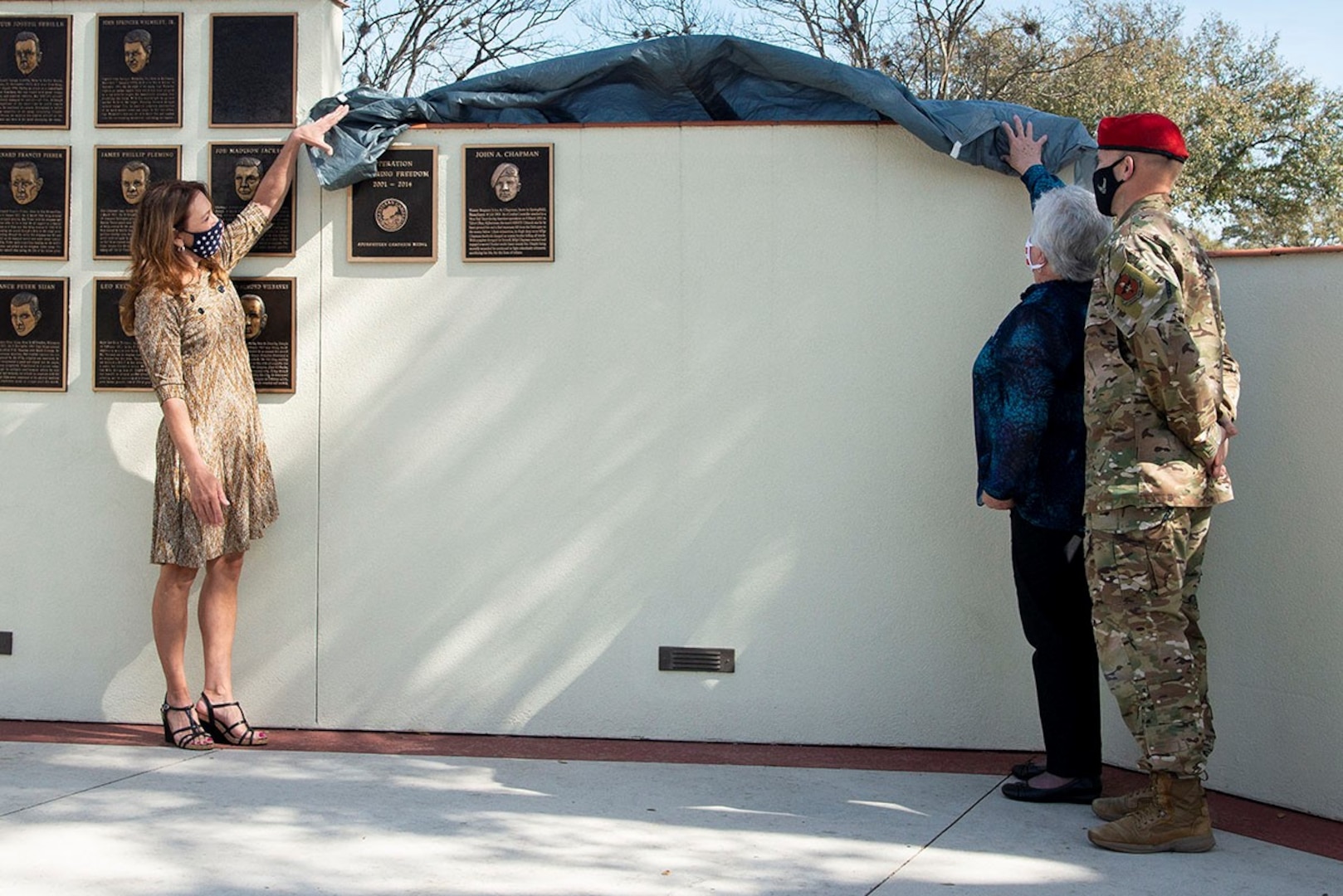 (left to right) Valerie Nessel, John Chapman’s spouse; Terry Chapman, John Chapman’s mother; and U.S. Air Force Col. Mason Dula, Special Warfare Training Wing commander, unveil the Master Sgt. John Chapman Medal of Honor plaque during a ceremony at Airmen’s Heritage Park at Joint Base San Antonio-Randolph March 4, 2021.