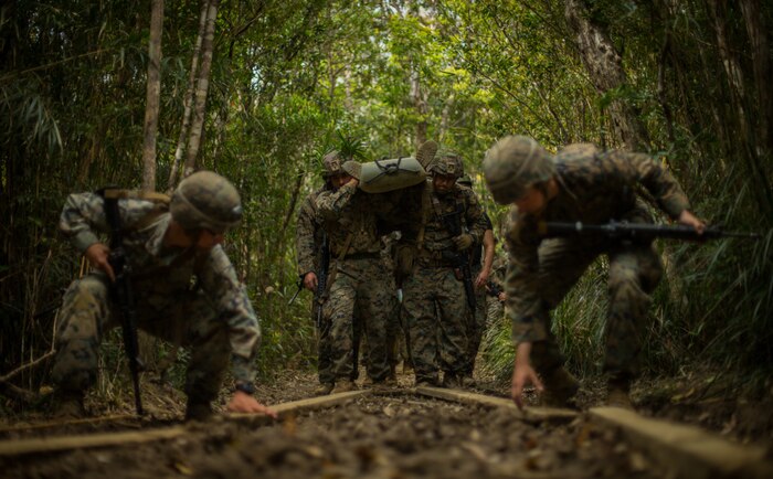 Marines and Soldiers conduct a casualty evacuation during the Basic Jungle Survival Course at the Jungle Warfare Training Center, Okinawa, Japan, Feb. 25, 2021.