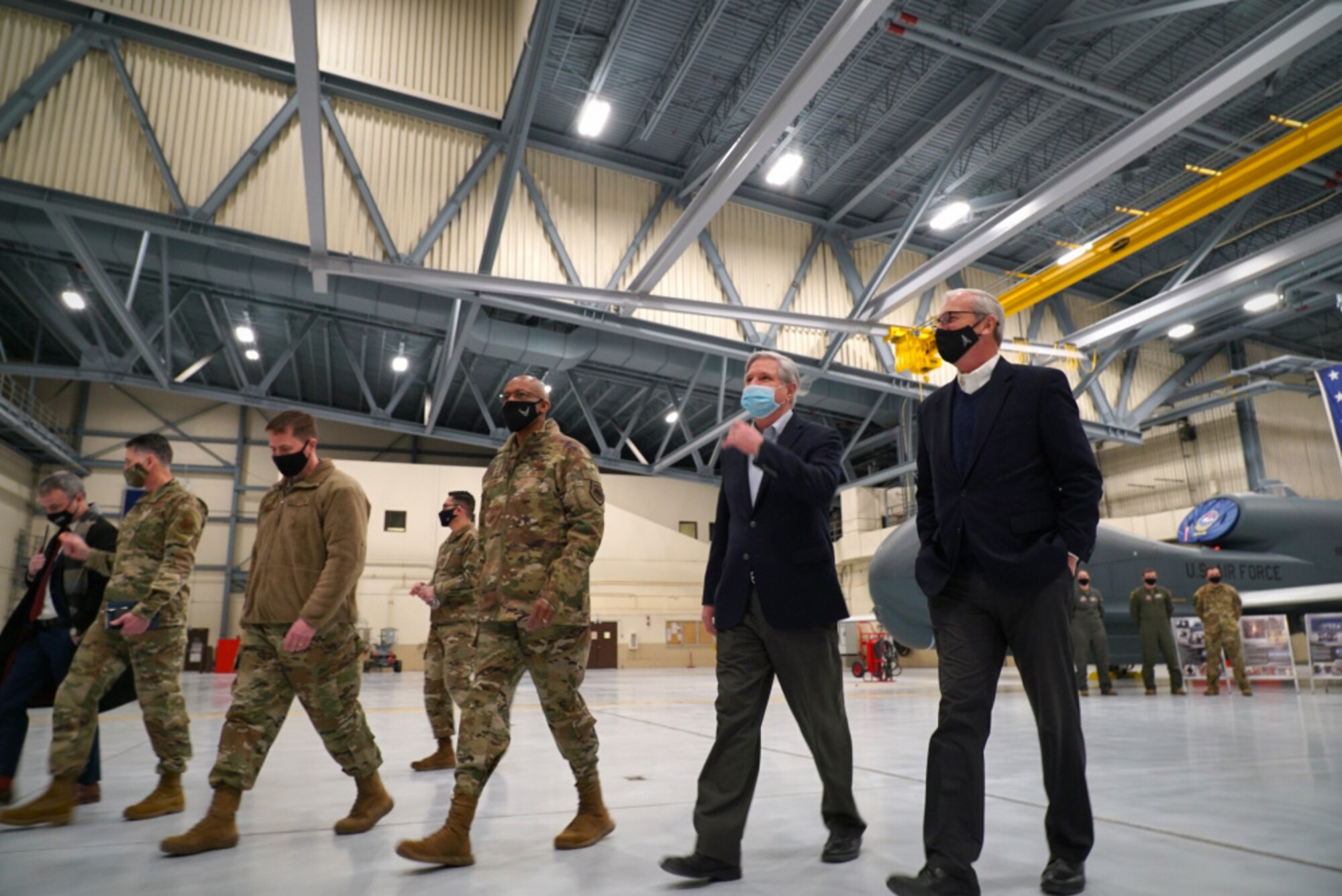 Col. Cameron Pringle, 319th Reconnaissance Wing commander, (third from left), Air Force Chief of Staff Gen. Charles Q. Brown, Jr., Sen. John Hoeven and Senator Kevin Cramer, depart an aircraft hangar at Grand Forks Air Force Base, N.D., Feb. 17, 2021. Brown received a brief from members of the 319th Aircraft Maintenance Squadron, who shared information regarding the critical role the RQ-4 Global Hawk plays in the Air Force’s intelligence, surveillance and reconnaissance mission. (U.S. Air Force photo by Staff Sgt. Elora J. McCutcheon)