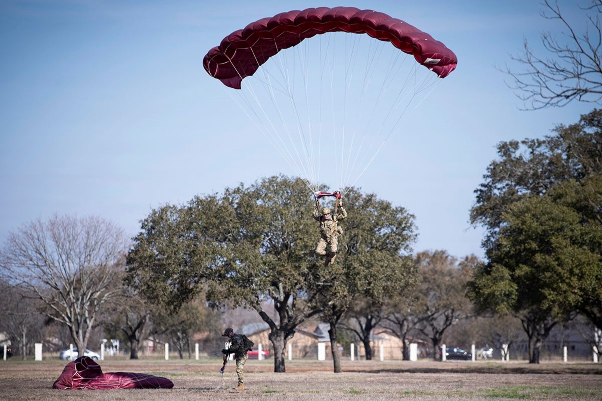 A member of the Special Warfare Training Wing prepares to land after parachuting over Airmen’s Heritage Park during a Medal of Honor plaque unveiling ceremony to honor Master Sgt. John Chapman at Joint Base San Antonio-Randolph March 4, 2021.