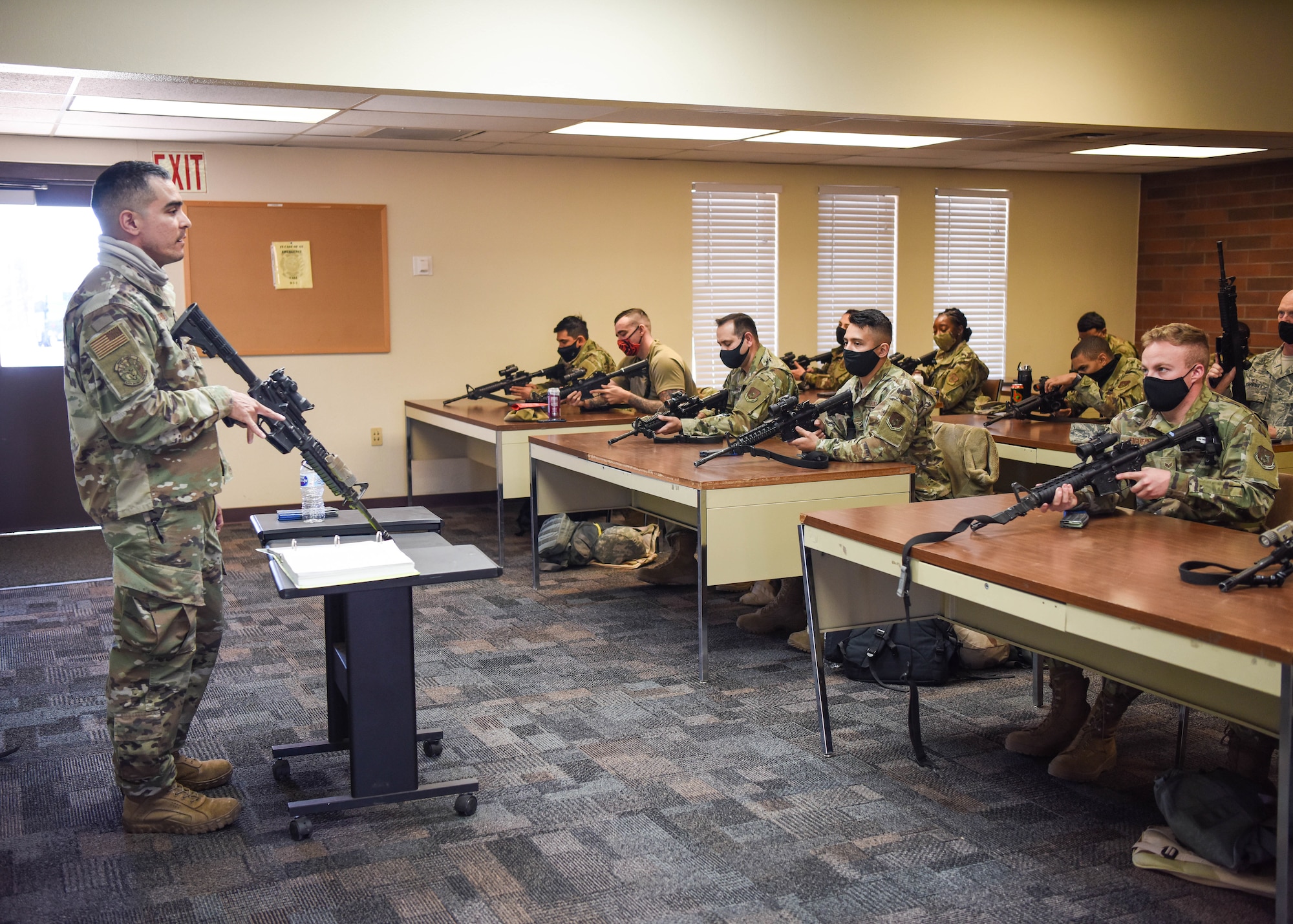 Airmen with the 944th Mission Support Group receive classroom instruction on weapons safety during a deployment training exercise, March 6, 2021 at Camp Navajo, Bellemont, Arizona. The first-of-its-kind exercise was conducted by the 944th MSG, aimed at bringing together four different squadrons with different missions in a simulated deployed environment.