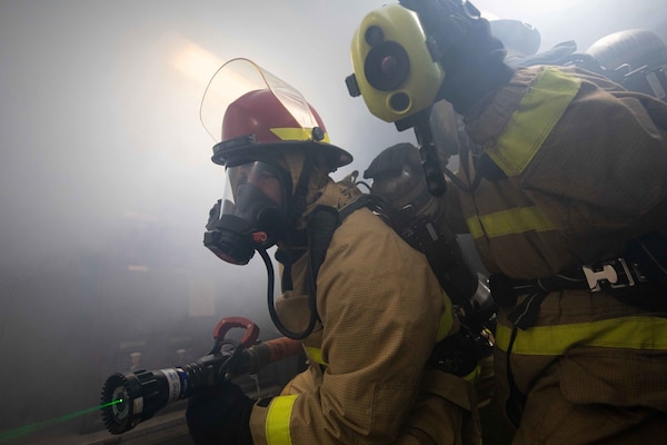 Sailors, assigned to the guided missile destroyers USS Mcfaul (DDG 74) and USS Mason (DDG 87), participate in a rescue and assistance drill with Sailors, assigned to the amphibious assault ship USS Bataan (LHD 5), in the upper vehicle stowage.