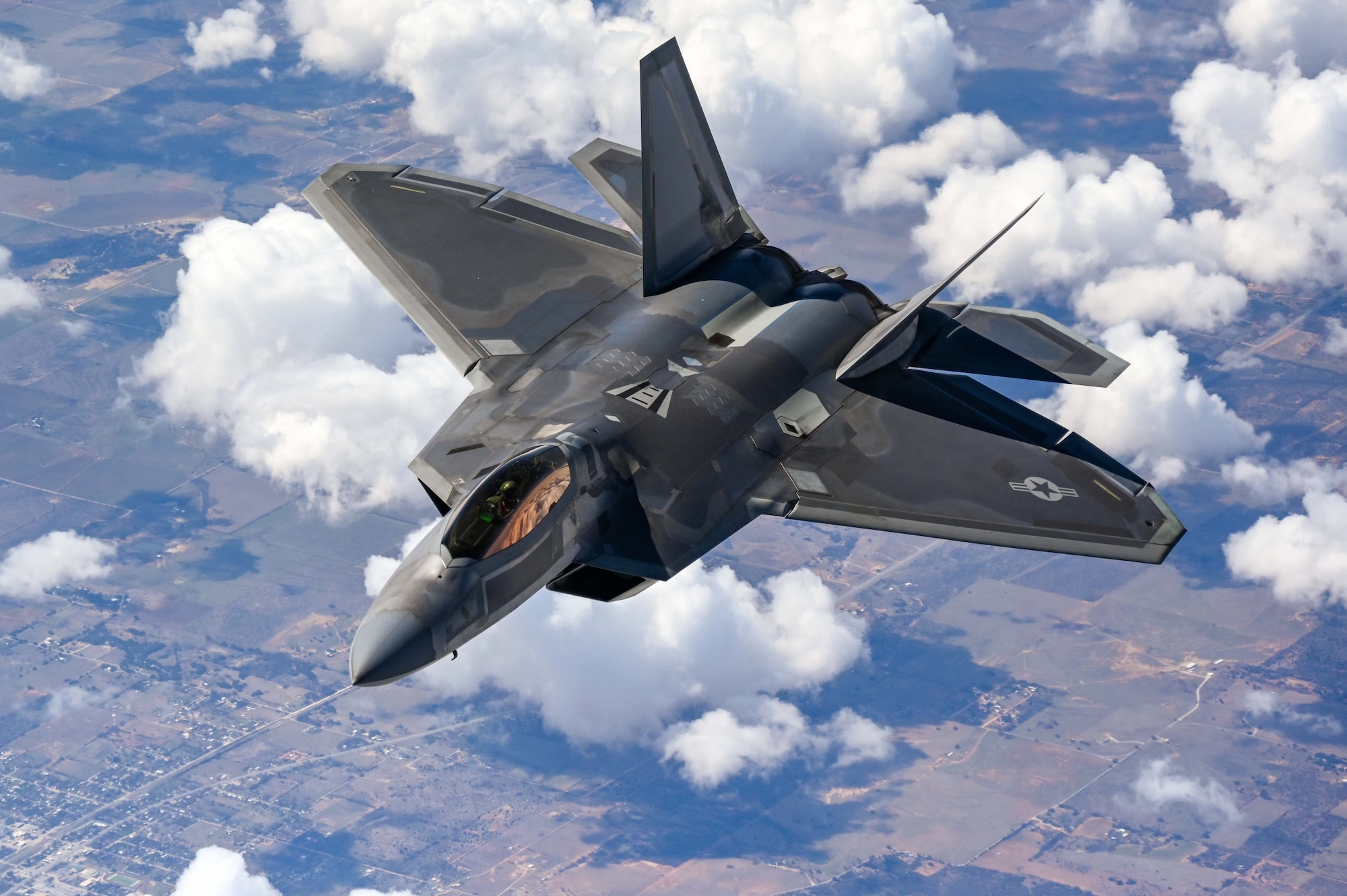 An F-22 Raptor Demonstration Team pilot flies behind a KC-135 Stratotanker from the 465th Air Refueling Squadron assigned to Tinker Air Force Base, Oklahoma, March 8. 2021. The F-22 team from Joint Base Langley–Eustis, Virginia, is assigne¬d to Air Combat Command and received fuel from the Okies during their flight back to their home station after performing at an air show. (U.S. Air Force photo by Senior Airman Mary Begy)