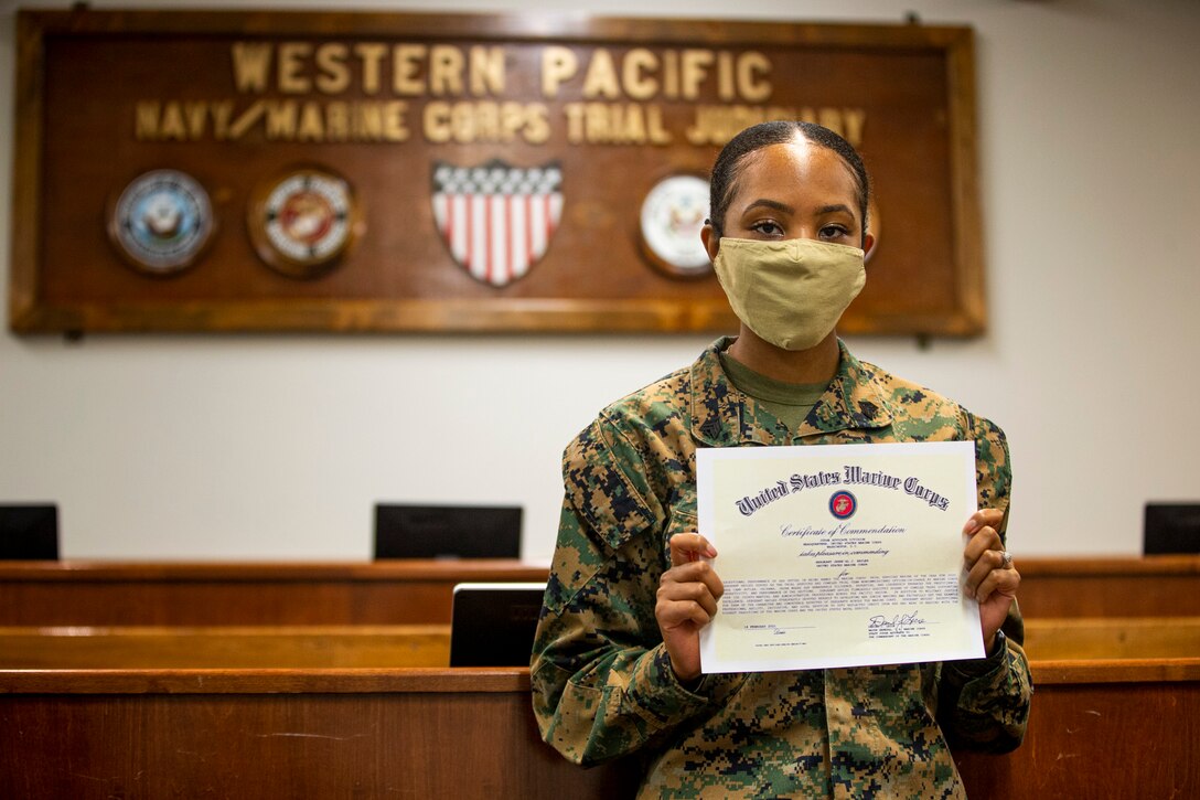 U.S. Marine Corps Sgt. Jerre’al Hayles, a Pacific trial team paralegal with the Legal Service Support Section, displays her certificate of commendation for winning the 2020 Trial Service Office (TSO) Marine of the Year award on Camp Foster, Okinawa, Japan, March 10, 2021. Hayles won the 2020 TSO Marine of the Year award for going above and beyond the expectations and duties within the unit. Hayles is a native of Smithfield, Virginia. (U.S. Marine Corps photo by Cpl. Karis Mattingly)
