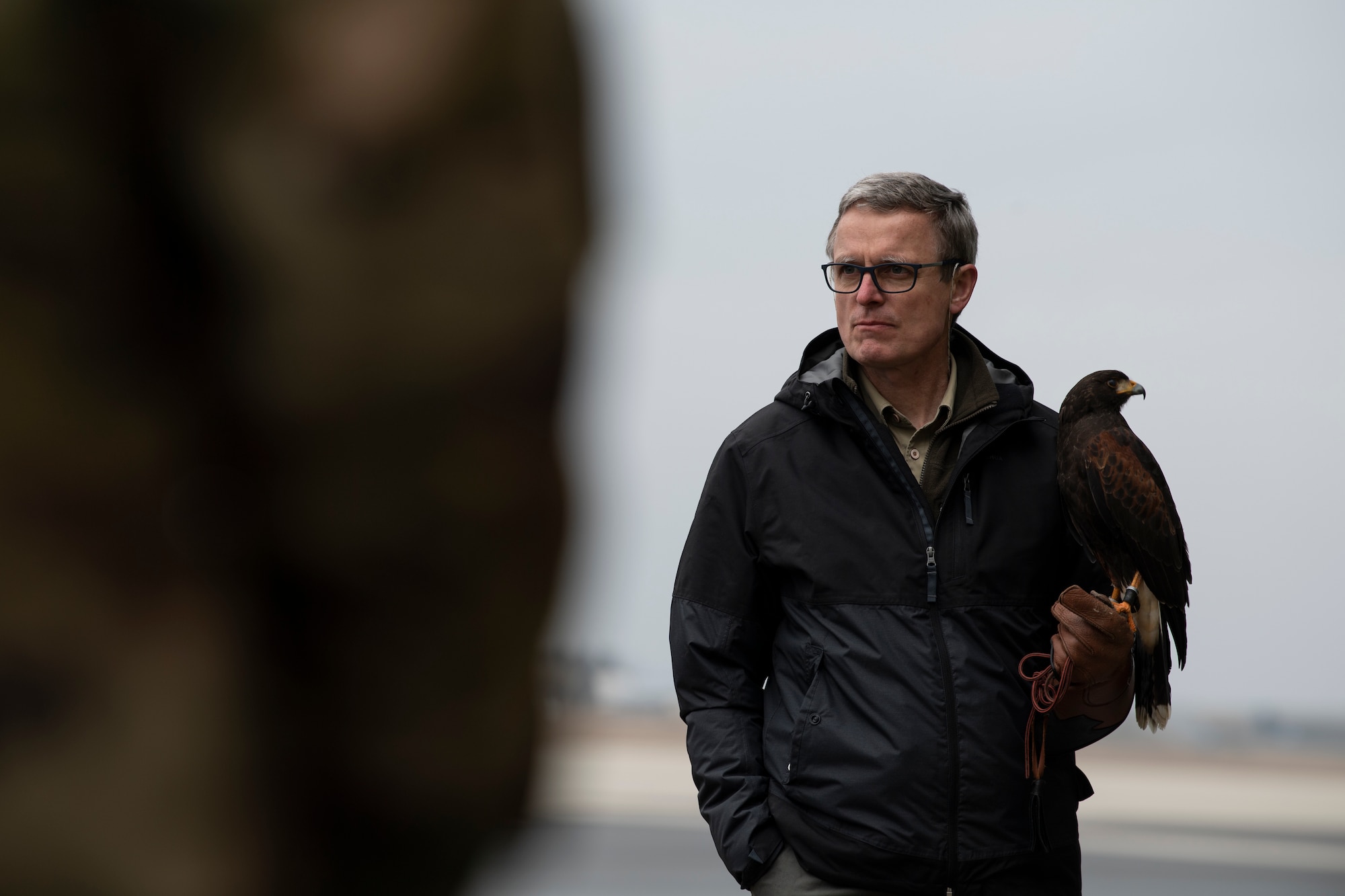 Jens Fleer, 52nd Fighter Wing base falconer, holds his hawk, Jack, as he speaks to U.S. Air Force members of the 726th Air Mobility Squadron during a Bird and Wildlife Aircraft Strike Hazard (BASH) briefing at the 726th AMS on Spangdahlem Air Base, Germany, March 5, 2021.